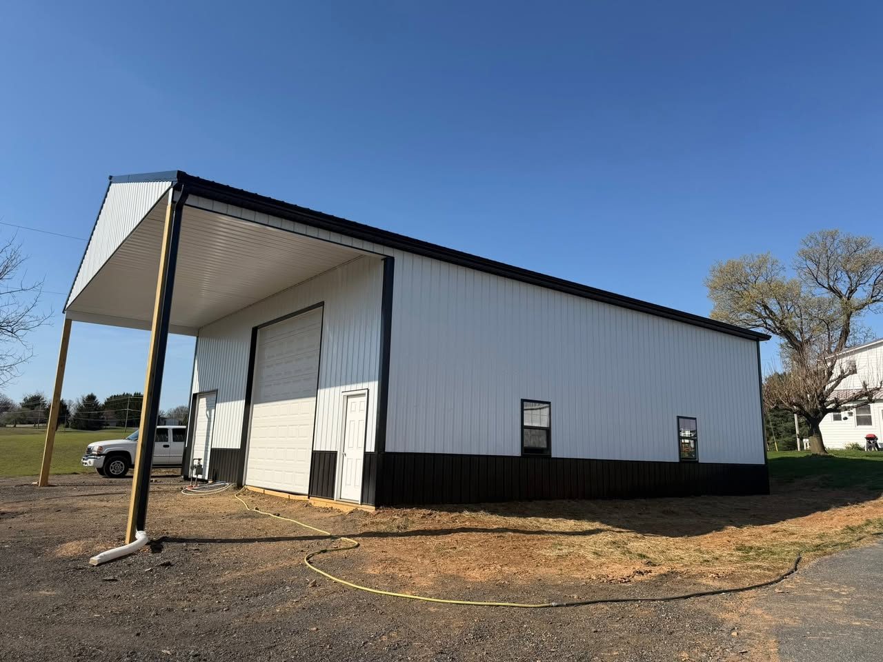 Black and gray custom pole building garage with multiple doors in Maryland