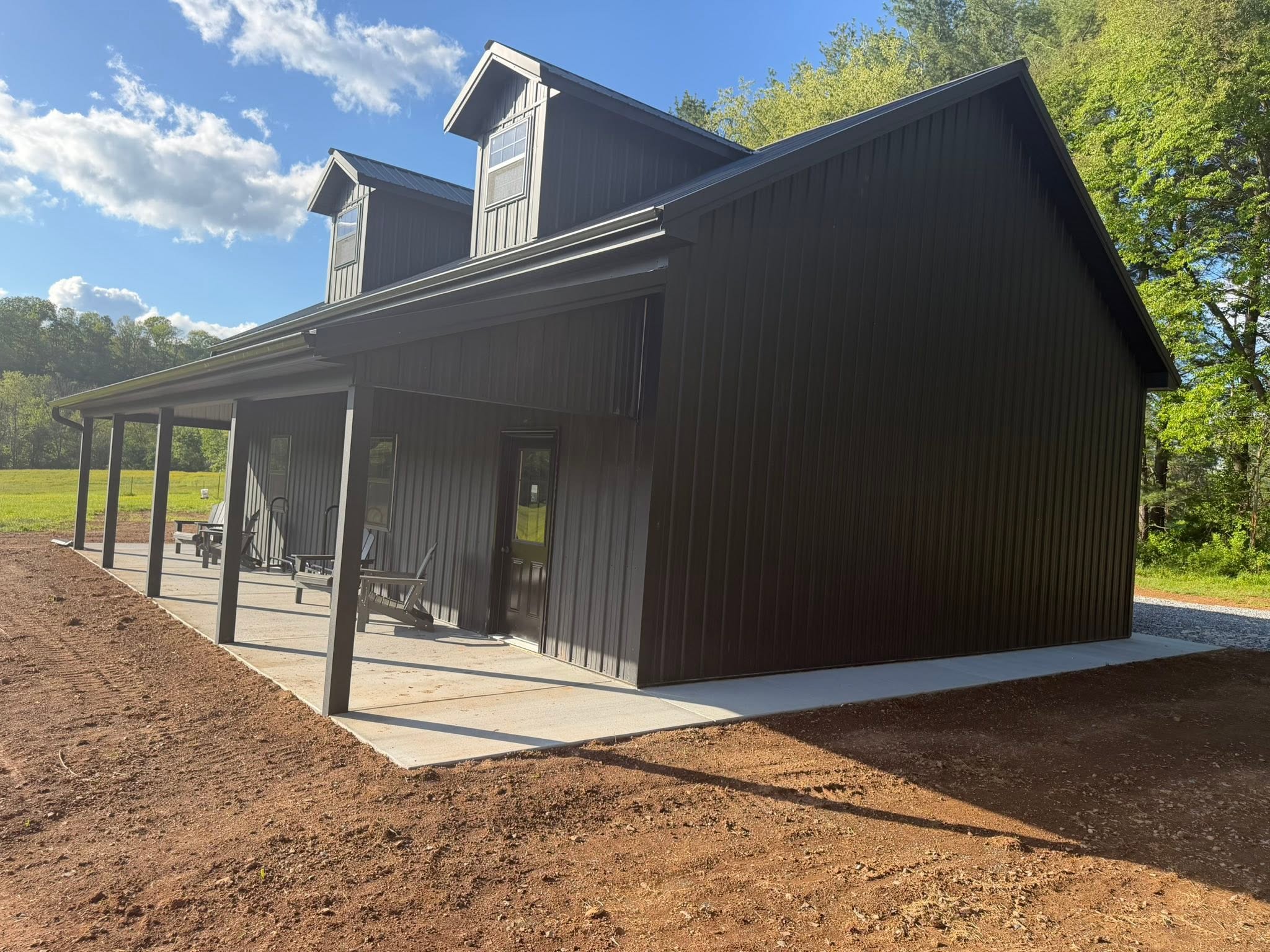 Modern two-story black barndominium built in Maryland
