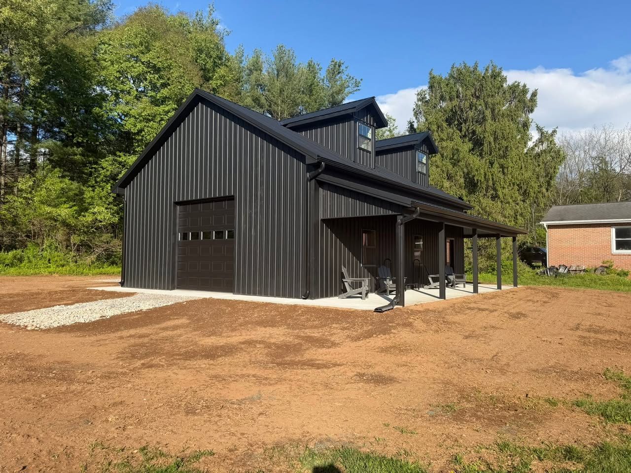All-black textured steel 30x40 pole barn with room truss and 10-foot covered porch, built by Pole Buildings Plus in Maryland