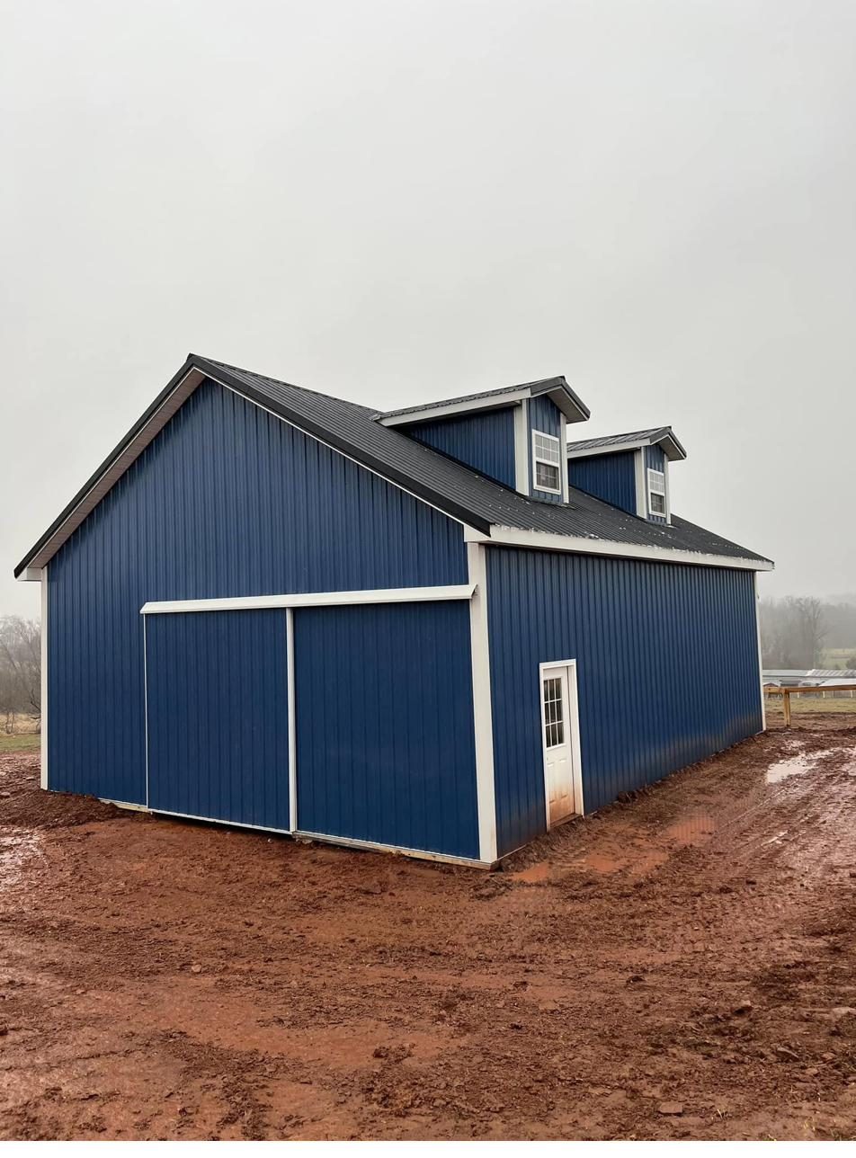 Blue metal pole barn garage with gable roof built by Pole Buildings Plus in Maryland