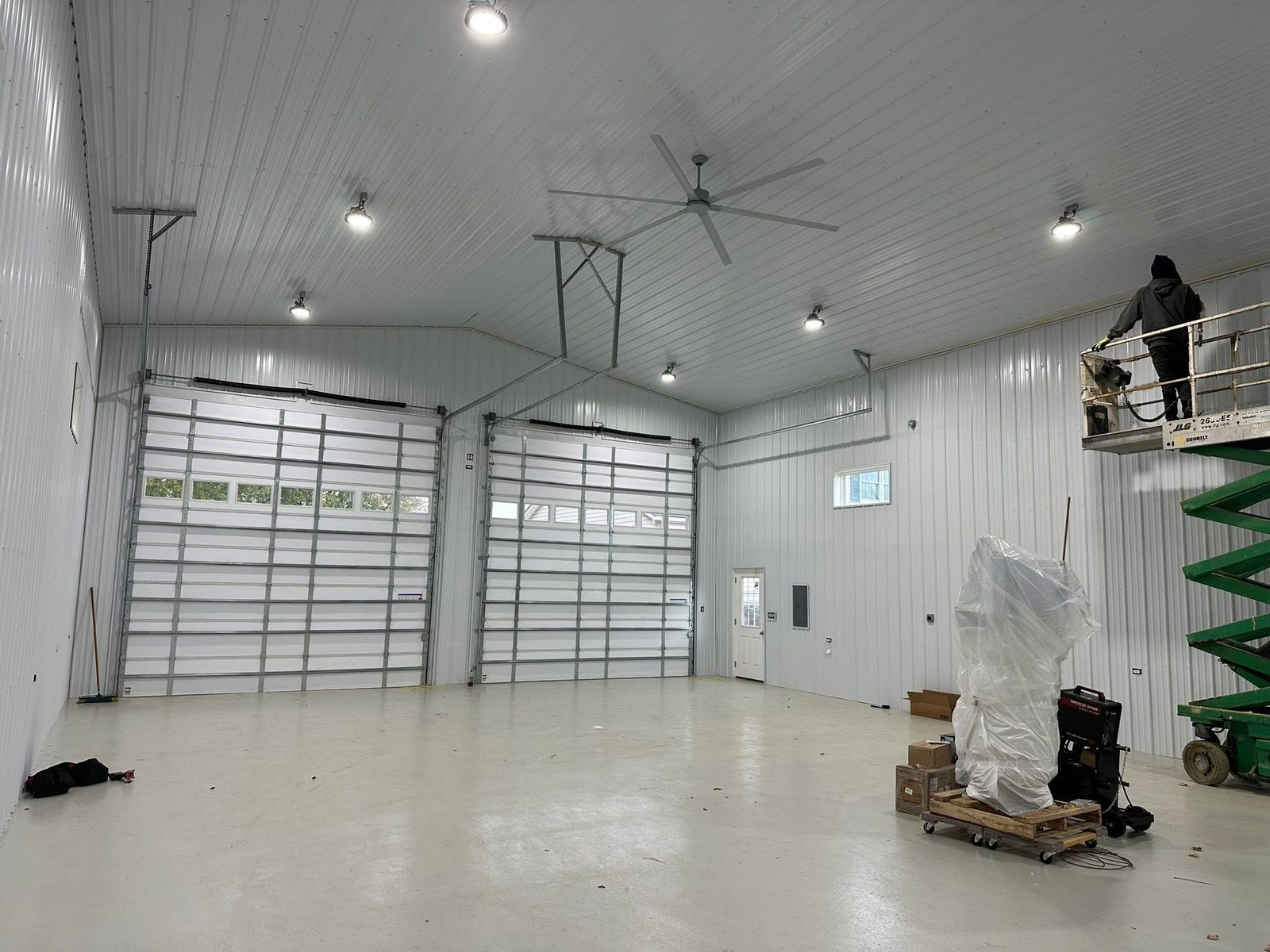 Pole building interior with scissor trusses and white steel liner panels in Maryland