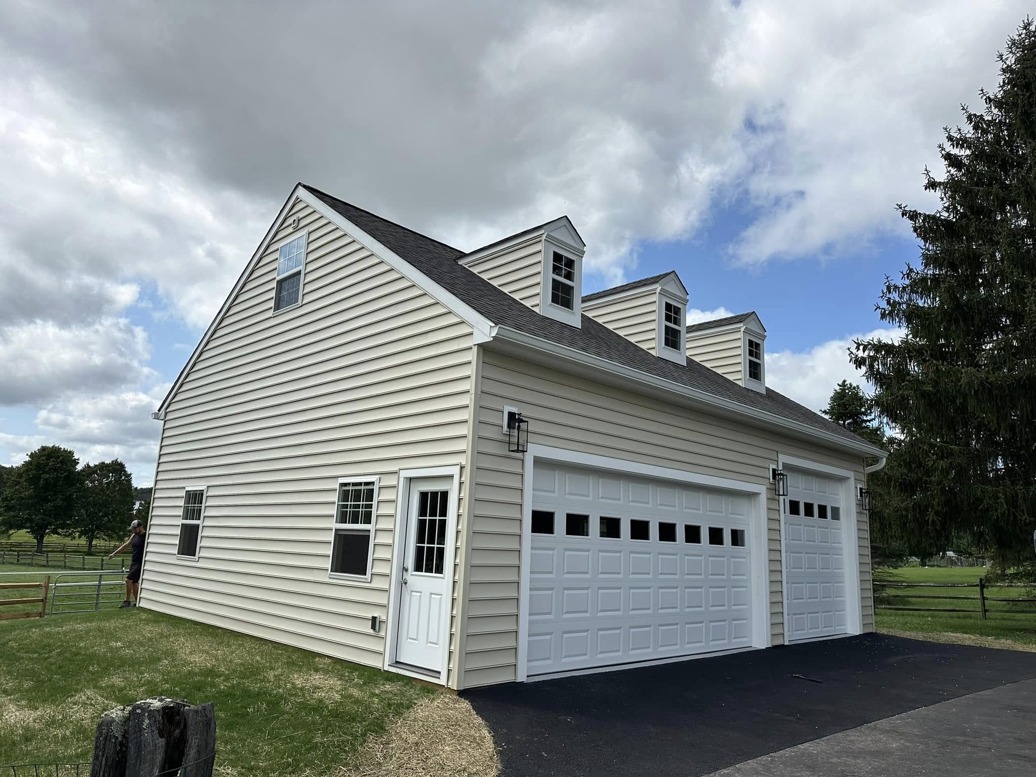 Finished two-story detached garage with dormers and vinyl siding built by Pole Buildings Plus
