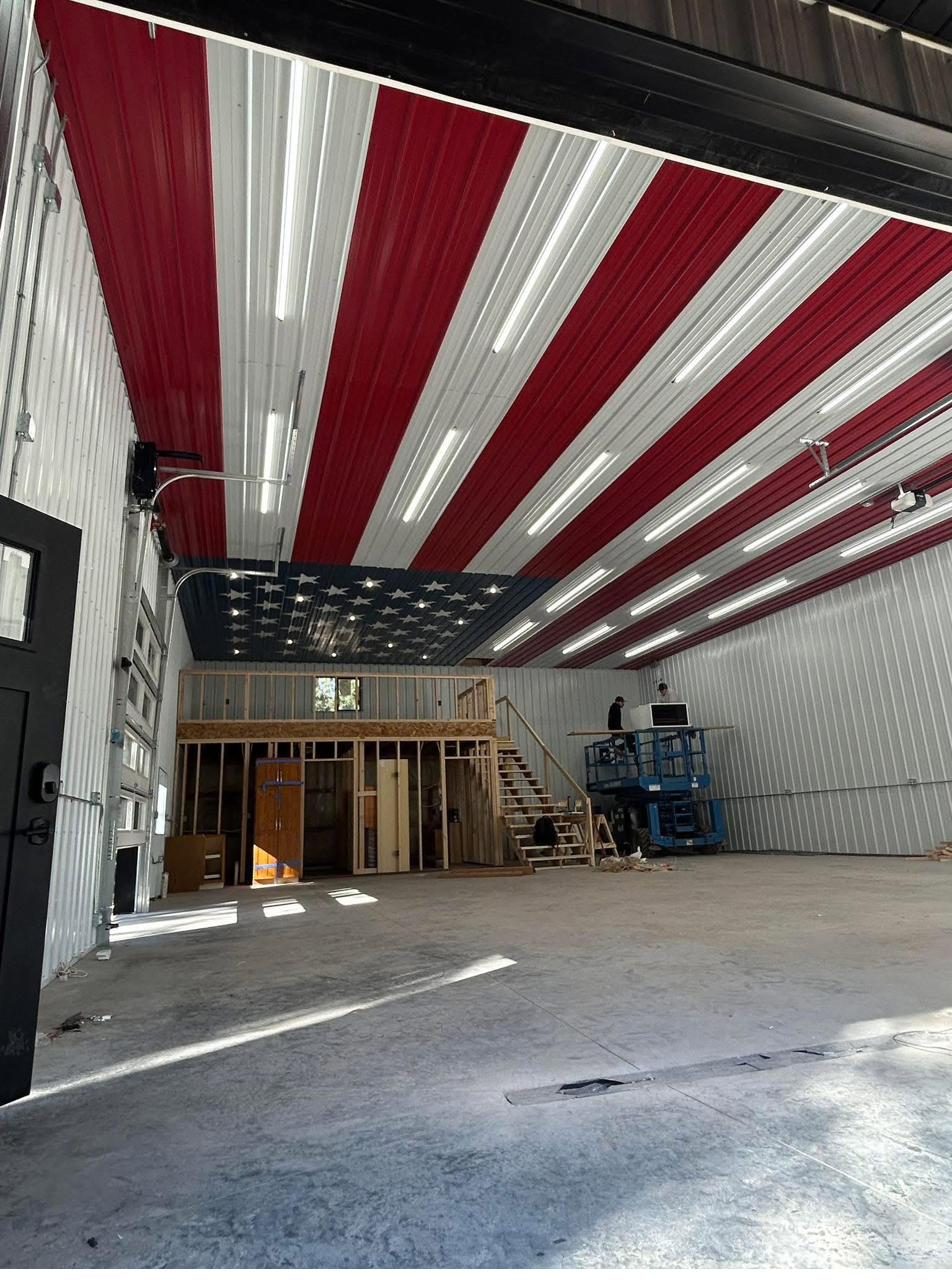 Finished pole building workshop interior with American flag ceiling detail in Maryland